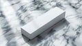 Simple white rectangular box on a marble surface under soft light Royalty Free Stock Photo