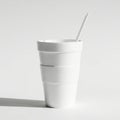 A simple white styrofoam cup with a straw casting a shadow on a white background Royalty Free Stock Photo