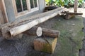 A simple wooden bench placed atop stones, providing a rustic resting spot outside the house Royalty Free Stock Photo