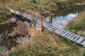 A simple wooden bridge on a forest river Royalty Free Stock Photo