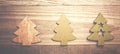 Simple wooden Christmas trees on a green wooden background.Craf