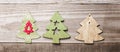 Simple wooden Christmas trees on a green wooden background.Craf