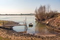 Simple wooden jetty with a rowing boat in the water