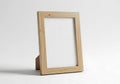 Simple wooden photo frame standing on a plain background ready for personalization Royalty Free Stock Photo