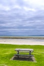Wooden picnic table by a beach Royalty Free Stock Photo