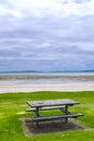 Wooden picnic table by a beach Royalty Free Stock Photo