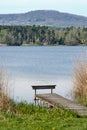 A simple wooden pier on a shore of lake or pond in Holany, Czech Republic Royalty Free Stock Photo