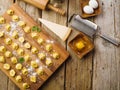 On a simple wooden table, homemade dumplings on a cutting board, ingredients, kitchen utensils. Food background. Low angle view. Royalty Free Stock Photo