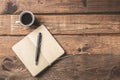 Simple work place. Wooden office desk table,  with empty notebook,pen and coffe. Morning planner concept Royalty Free Stock Photo