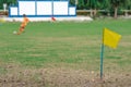 A simple yellow flag on the corner of football field in school. Place for corner kick on soccer ball. Soccer field corner with Royalty Free Stock Photo