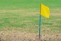 A simple yellow flag on the corner of football field in school. Place for corner kick on soccer ball. Soccer field corner with Royalty Free Stock Photo