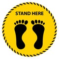 Black footprint and wording stand here on yellow-black tape sign.Social distancing concept for preventing corona virus covid-19.