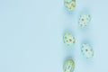 Simplicity and minimal easter background - blue eggs with gold design as border on blue color, top view. Royalty Free Stock Photo