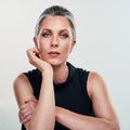 Simplicity is the ultimate form of sophistication. Studio portrait of a beautiful mature woman posing against a grey