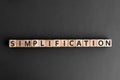 Simplification - word from wooden blocks with letters