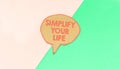 Simplify your life speech bubble isolated on green and blue background Royalty Free Stock Photo