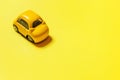 Simply design yellow vintage retro toy car isolated on yellow background. Automobile and transportation symbol. City traffic