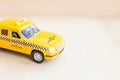 Simply design yellow vintage retro toy car Taxi Cab model on wooden background. Automobile and transportation symbol. City traffic Royalty Free Stock Photo