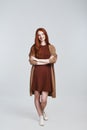 Simply happy Full-length photo of cheerful and cute young redhead lady in casual clothing smiling and looking at camera Royalty Free Stock Photo