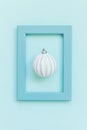 Simply minimal composition winter objects ornament ball in blue frame isolated on blue pastel trendy background