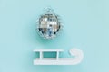 Simply minimal composition winter objects ornament ball sled isolated on blue pastel trendy background