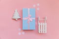 Simply minimal composition winter objects ornament fir tree sled gift box isolated on pink pastel trendy background