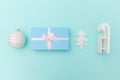 Simply minimal composition winter objects ornament sled fir tree ball gift box isolated on blue pastel trendy background