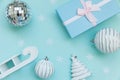 Simply minimal composition winter objects ornament sled fir tree ball gift box isolated on blue pastel trendy background