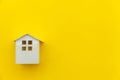 Simply minimal design with miniature white toy house isolated on yellow colourful trendy modern fashion background Royalty Free Stock Photo