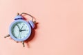 Simply minimal design ringing twin bell vintage classic alarm clock Isolated on pink pastel background. Rest hours time of life