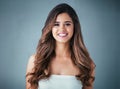 Simply, stunning. Studio portrait of a beautiful young woman posing against a gray background.