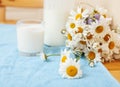 Simply stylish wooden kitchen with bottle of milk and glass on table, summer flowers camomile, healthy foog moring Royalty Free Stock Photo