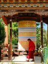 Monk turning prayer wheel at Simtokha Dzong in Bhutan