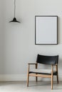 The simulation of a black frame with a white coating contrasts with the plain white wall. and simple furniture