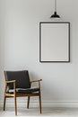 The simulation of a black frame with a white coating contrasts with the plain white wall. and simple furniture