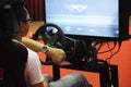 Simulation of race car video player game with big screen monitors and cockpit controls like a racing car. Royalty Free Stock Photo