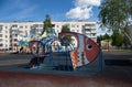 A simulator in the form of a fish on a playground in the city in summer