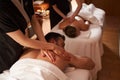 Simultaneous massage for two young people in spa salon