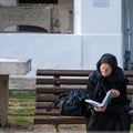 Religious orthodox woman reading in Sinaia