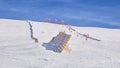 Sinaia ski domain. View of a medium difficulty slope in Valea Dorului, a wooden protection fence, and an old, red, chairlift.