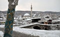 Sinan Pasha Mosque and Stone bridge covered with snow, Kosovo