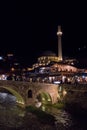 Sinan Pasha Mosque and stone bridge, landmarks in the city of Prizren, Kosovo, at night.