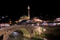 Sinan Pasha Mosque and stone bridge, landmarks in the city of Prizren, Kosovo, at night.