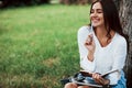 Sincere emotions. Young woman have weekend and sits in the park at daytime Royalty Free Stock Photo