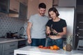 Sincere smiles. Young couple in the modern kitchen at home at their weekend time in the morning Royalty Free Stock Photo