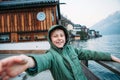 Sincerely smiling boy near the bot pier on mountain lake Royalty Free Stock Photo