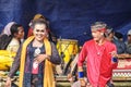 A sinden or singer of transgender Javanese folk songs dancing with male dancers while enjoying the music that is being played Royalty Free Stock Photo