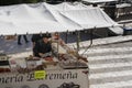 Sineu, Majorca. Working man placing slices of serrano ham on a tray in the wednesday market