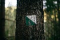 The sing of easy turistic route on the tree with green and white