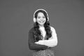 Sing with me. Girl cute little child wear headphones listen music. Kid listen music red background. Recommended music